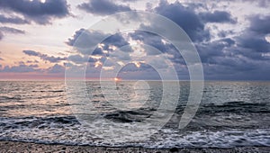 Autumn sunset on the Black Sea. Dark disturbing clouds