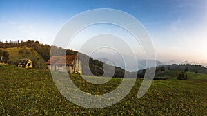 Autumn sunset at hillsides and meadow with mist over Danube river photo