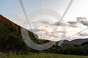 Autumn sunset orange green vibrant landscape rural power lines clouds blue sky hillside forest trees beautiful bulgaria