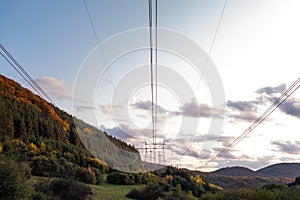 Autumn sunset orange green vibrant landscape rural power lines clouds blue sky hillside forest trees beautiful bulgaria