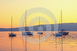 Autumn sunset with sailboats on water. Kotor Bay, Montenegro