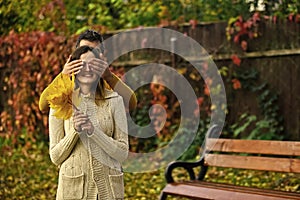 Autumn surprises. Man and woman with yellow tree leaves.