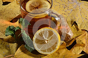 Autumn tea. Hot tea on table covered by autumn leves