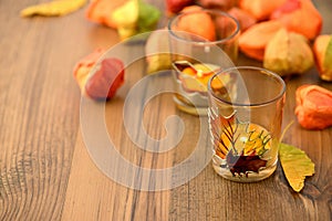 Autumn tealight decoration on table with chinse lantern seeds