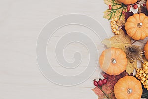 Autumn thanksgiving background. Leaves, pumpkins on wooden background.