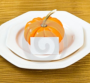 Autumn Thanksgiving dinner table setting with pumpkin