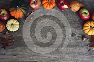 Autumn Thanksgiving Harvest Background with Apples, Pumpkins, Pears, Leaves, Acorn Squash and Nut Border Over Wood, Shot Directly