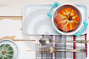 Autumn Thanksgiving table setting for dinner with plate, knife, fork decorated pumpkins. Top view