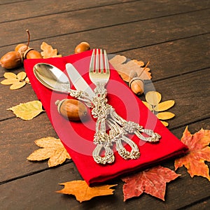 Autumn thanksgiving table with tableware and red tissue