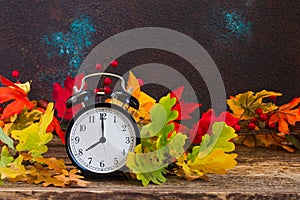 Autumn time - fall leaves with clock