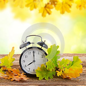 Autumn time - fall leaves with clock