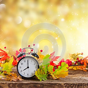 Autumn time - fall leaves with clock