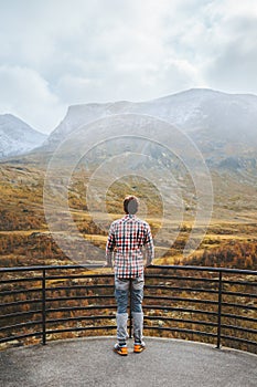 Autumn travel outdoor man looking at view forest and mountains in Norway healthy lifestyle