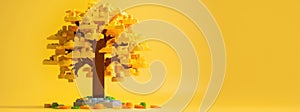 Autumn tree made of plastic construction blocks on yellow web banner. Toy trees made of childrens blocks on a yellow background