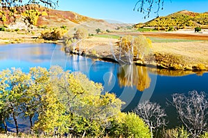 The autumn trees and blue water of Toad dam