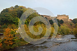 Autumn trees by the river swale and richmond castle