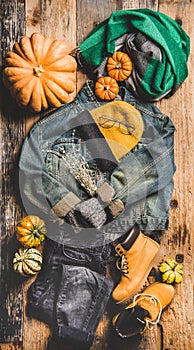 Autumn trendy women outfit layout over wooden background, top view