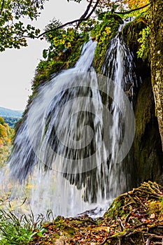 Autumn trip to Croatia, the park Plitvice Lakes. Picturesque splashing waterfall over the lake. The concept of ecological, active