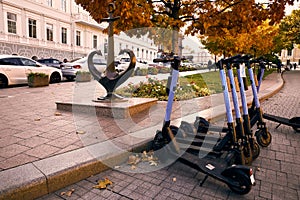 Autumn urbane landscape with electric scooter rental on st. Pushkinskaya near the Opera and Ballet Theatre. photo