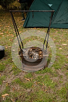 Autumn vacation concept. Man hiker make fire in forest