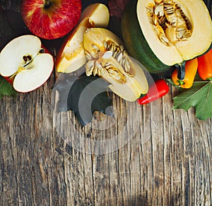 Autumn vegetables and fruits on wooden background.