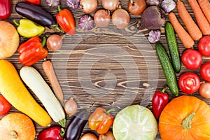 Autumn vegetables on a wooden background. Vegan organic food. Top view