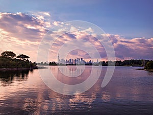 Autumn view from Tommy Thompson Park across bays of Lake Ontario with Toronto skyline and magnificent sunset skies with