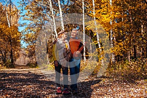 Autumn walk. Senior couple walking in fall park. Happy man and woman talking and relaxing outdoors