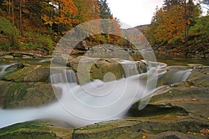 Autumn waterfall on mountain river