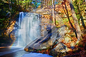 Autumn Waterfall Serenity in Forest with Rainbow Effect