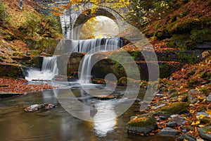 Autumn waterfalls near Sitovo, Plovdiv, Bulgaria. Beautiful cascades of water with fallen yellow leaves.