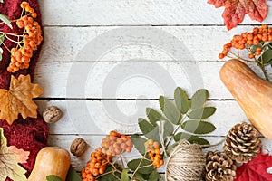 Autumn white wooden background with yellow maple leaves, pumpkins. Frame of fall harvest on aged wood with copy space. Mockup for