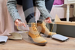 Autumn winter season, new shoes, close-up woman shoeing warm boots
