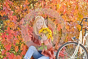 Autumn Woman with Autumn Leaves on Beautiful Fall Nature Background. Outdoor atmospheric fashion photo of young