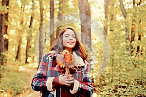 Autumn woman in autumn park with red pullover. Outdoor portrait Gorgeous brunette model girl with sunny day light. Copy