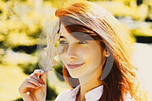 Autumn woman with autumnal mood. Autumn Beauty. Outdoor portrait Gorgeous model girl with sunny day light. Beautiful