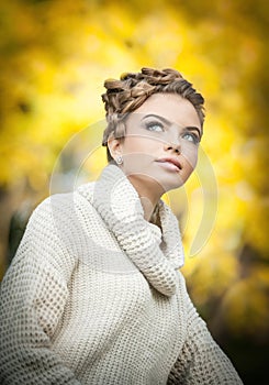 Autumn Woman. Beautiful creative makeup and hair style in outdoor shoot .Beauty Fashion Model Girl with Autumnal Make up and Hair