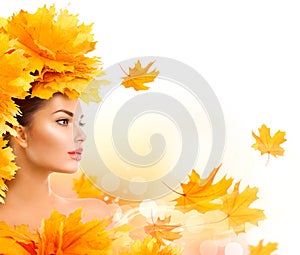 Autumn woman. Beauty model girl with autumn bright leaves hairstyle