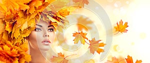 Autumn woman. Beauty model girl with autumn bright leaves hairstyle