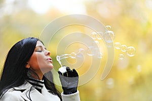 Autumn woman blow bubbles