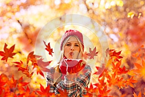 Autumn woman blowing fall leaves