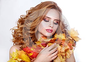 Autumn woman with bright leaves.