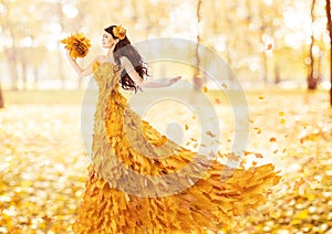 Autumn woman in fashion dress of fall maple leaves