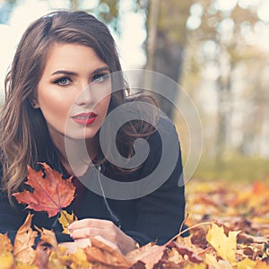 Autumn Woman Fashion Model with Fall Leaves