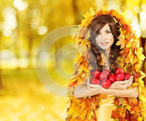 Autumn Woman holding Apples, Fashion Model in Yellow Fall Leaves