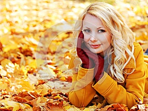 Autumn Woman with Maple leaves. Blonde Beautiful Girl in Fall