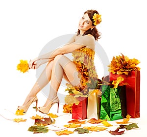 Autumn woman, shopping bags with yellow maple leaves