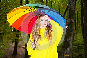 Autumn woman walking in the Park and enjoying the beautiful autumn nature. Pretty woman having fun at the park and