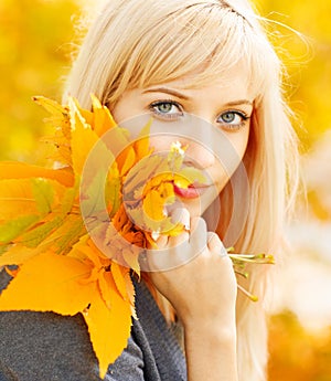 Autumn woman with yellow fall maple leaves