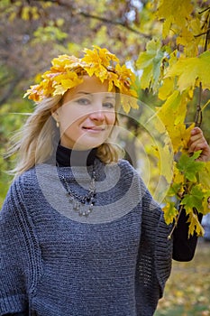 Autumn woman with yellow maple leaves